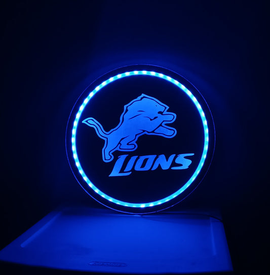 Blue neon sign with a logo on a dark background